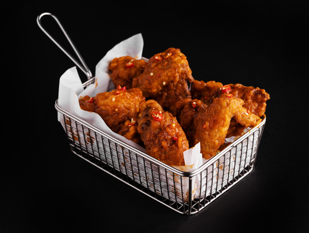 high-angle-shot-basket-delicious-fried-chicken-black-surface El-diablo, burger-with-red-pepper-horns-stone